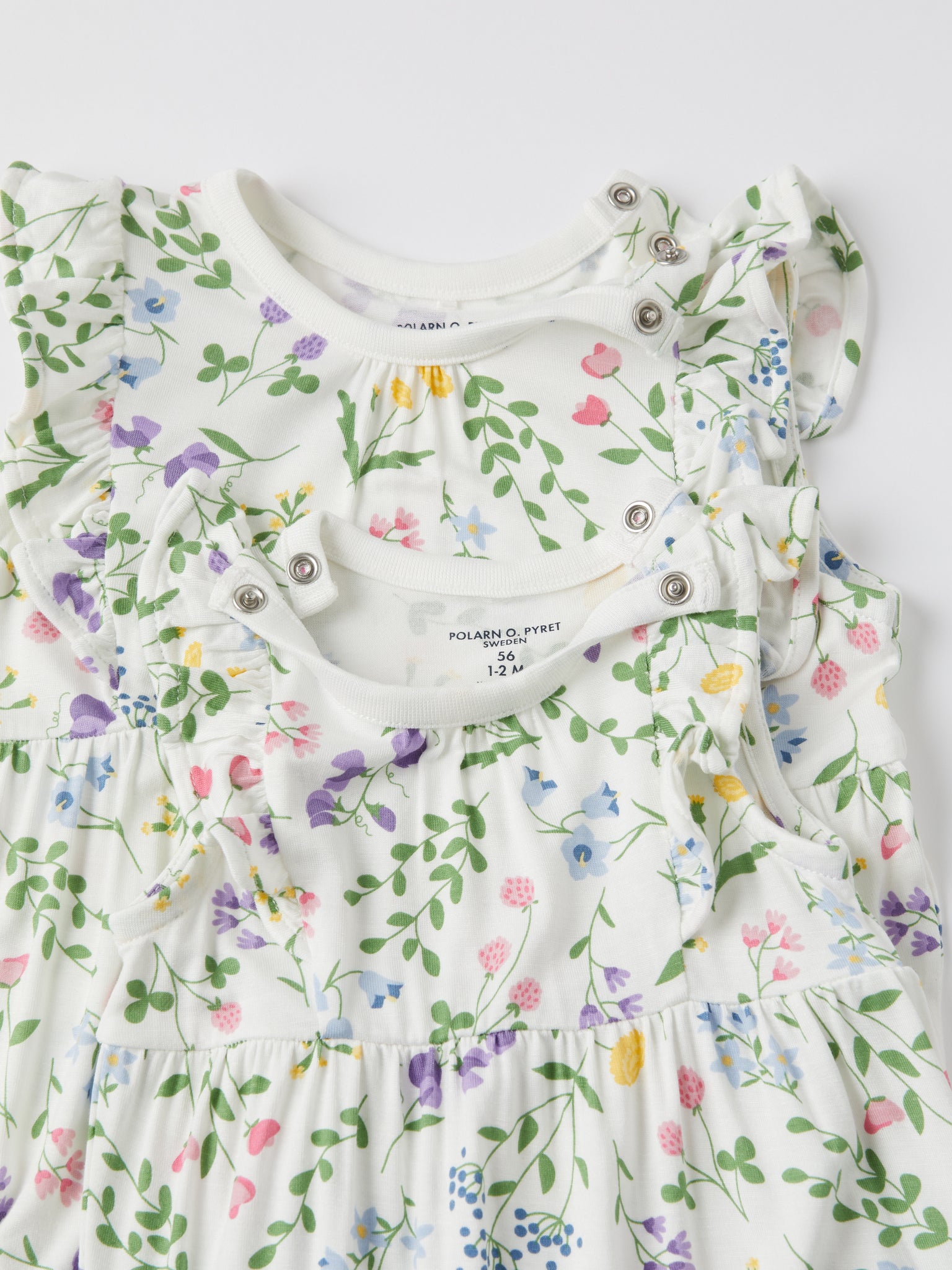 Pretty Ditsy Floral Cotton Baby Playsuit from the Polarn O. Pyret baby collection. Ethically produced kids clothing.
