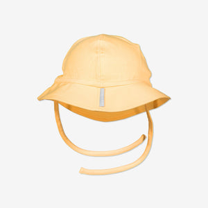 Adorable yellow coloured unisex baby sun hat with tie strings under the chin. Made with 100% organic cotton.