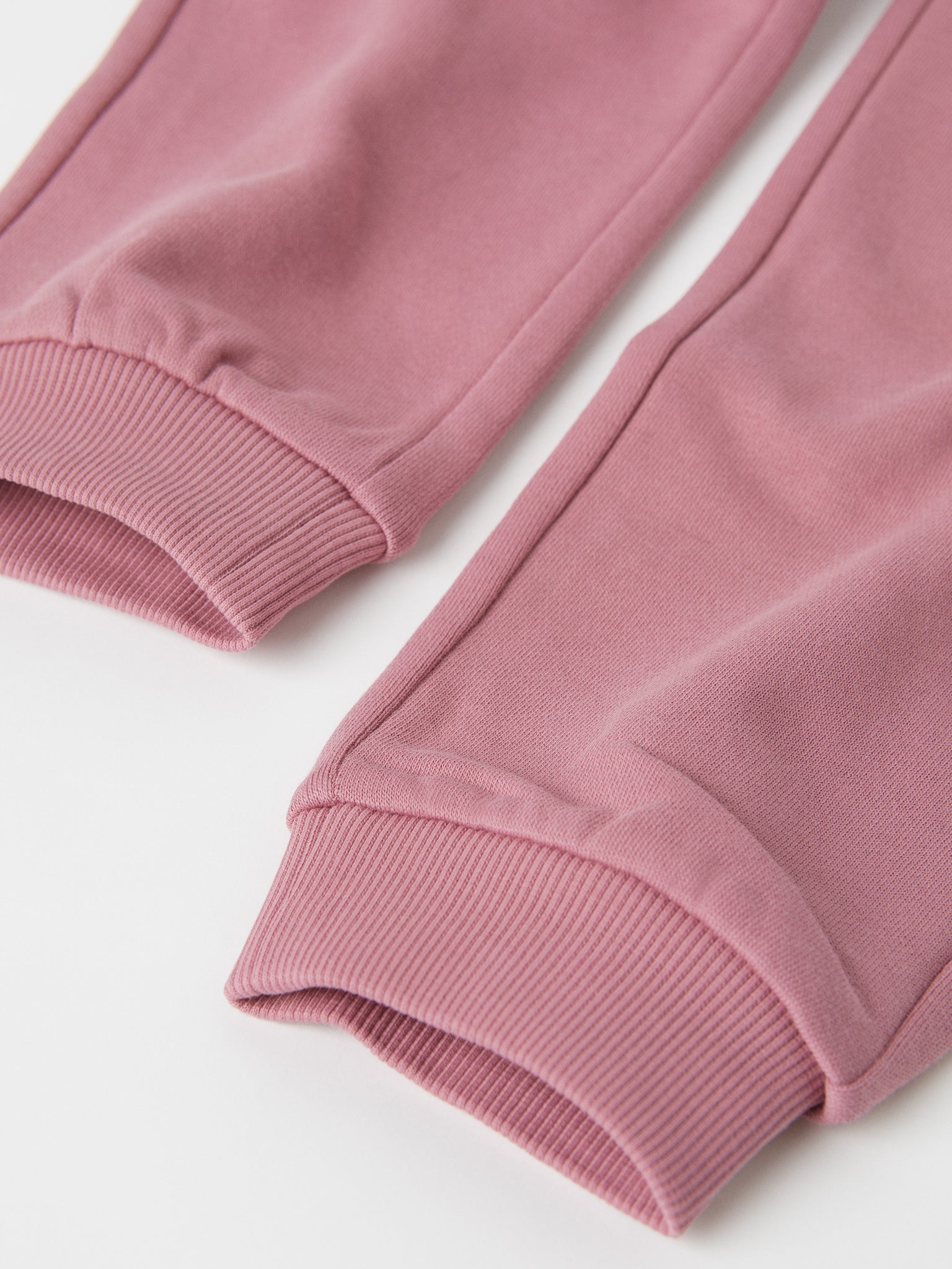 Organic Cotton Pink Kids Joggers from the Polarn O. Pyret kidswear collection. Clothes made using sustainably sourced materials.