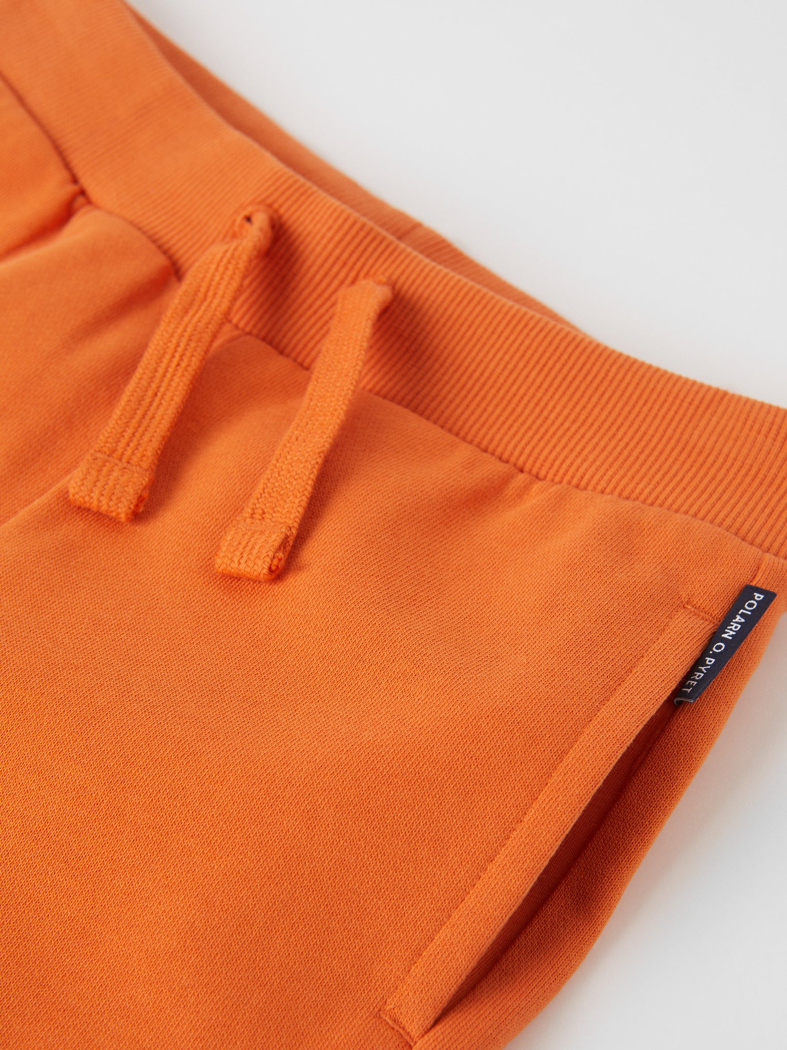 Organic Cotton Orange Kids Joggers from the Polarn O. Pyret kidswear collection. Made using 100% GOTS Organic Cotton