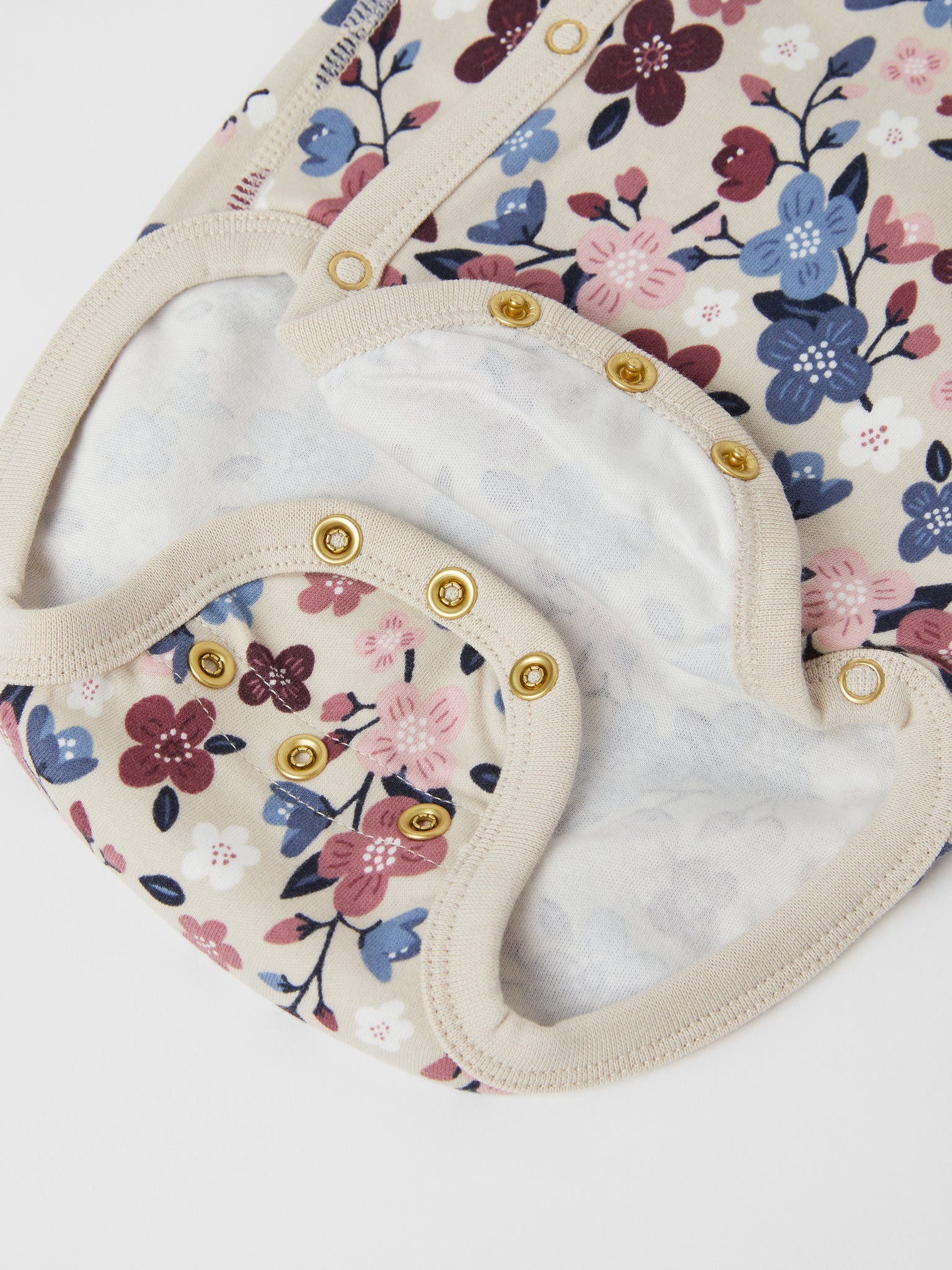 Organic Floral Wrapround Babygrow from the Polarn O. Pyret baby collection. Made using 100% GOTS Organic Cotton