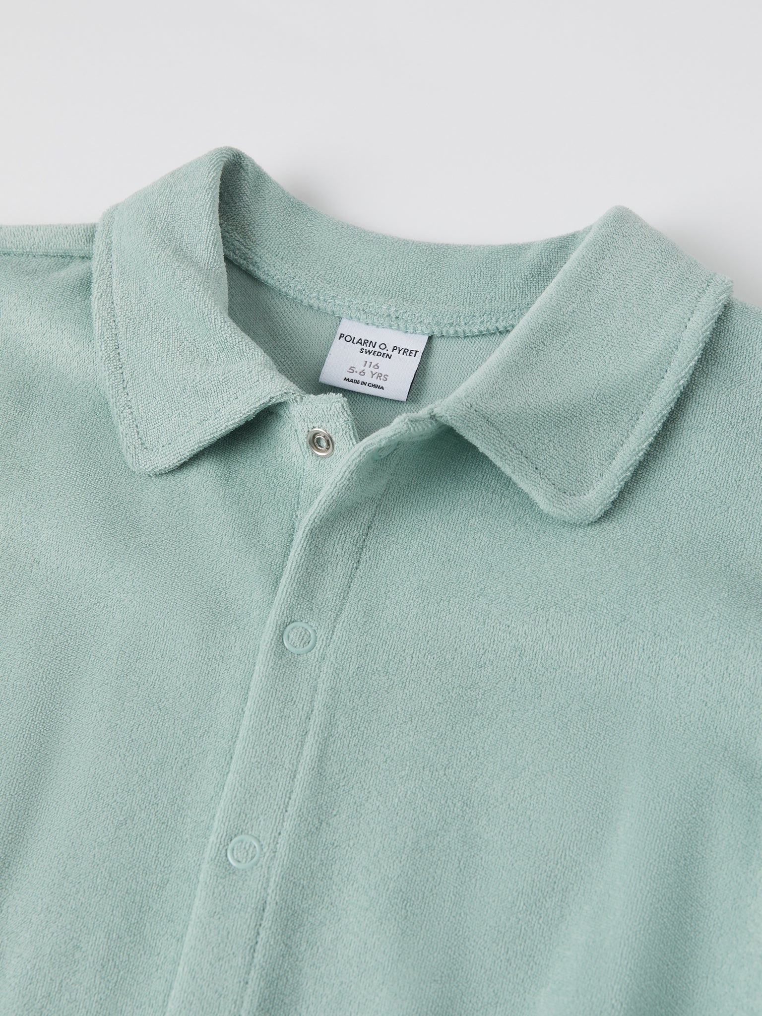Green Cotton Kids Polo Shirt from the Polarn O. Pyret kidswear collection. Ethically produced kids clothing.