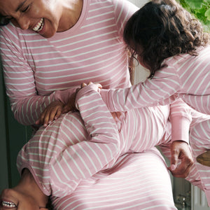 family wearing pink and white striped baby sleepsuit, organic cotton warm and comfortable, long lasting ethical clothes polarn o. pyret 