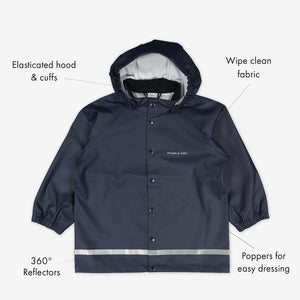 Navy, kids waterproof raincoat, made with shell fabric, includes elastic cuffs, detachable hood, reflectors & popper buttons.