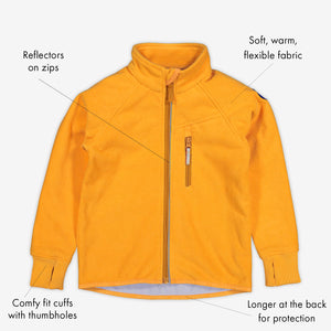 Yellow, kids waterproof fleece jacket made of soft and flexible fabric, with reflectors on zips & cuffs with thumbholes.