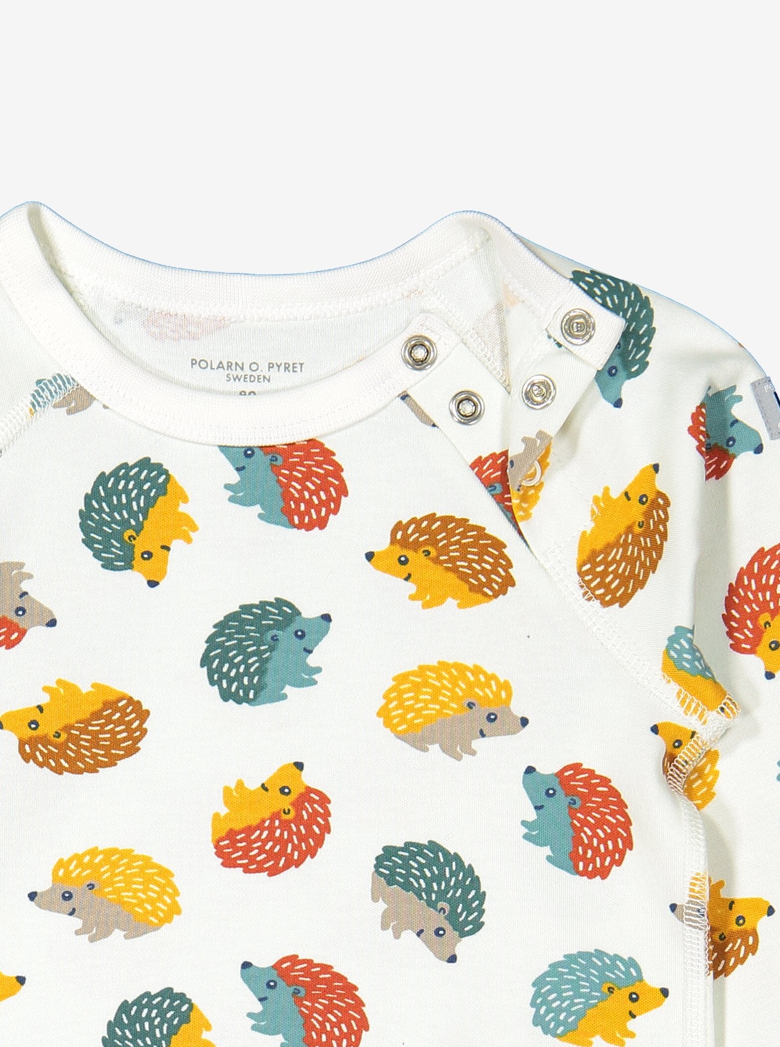 Close up of unisex hedgehog print organic cotton babygrow showing quality shoulder popper fastening for easy dressing