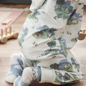 Close up of baby wearing unisex bunny print onesie in GOTS organic cotton. Paired with matching bunny print socks