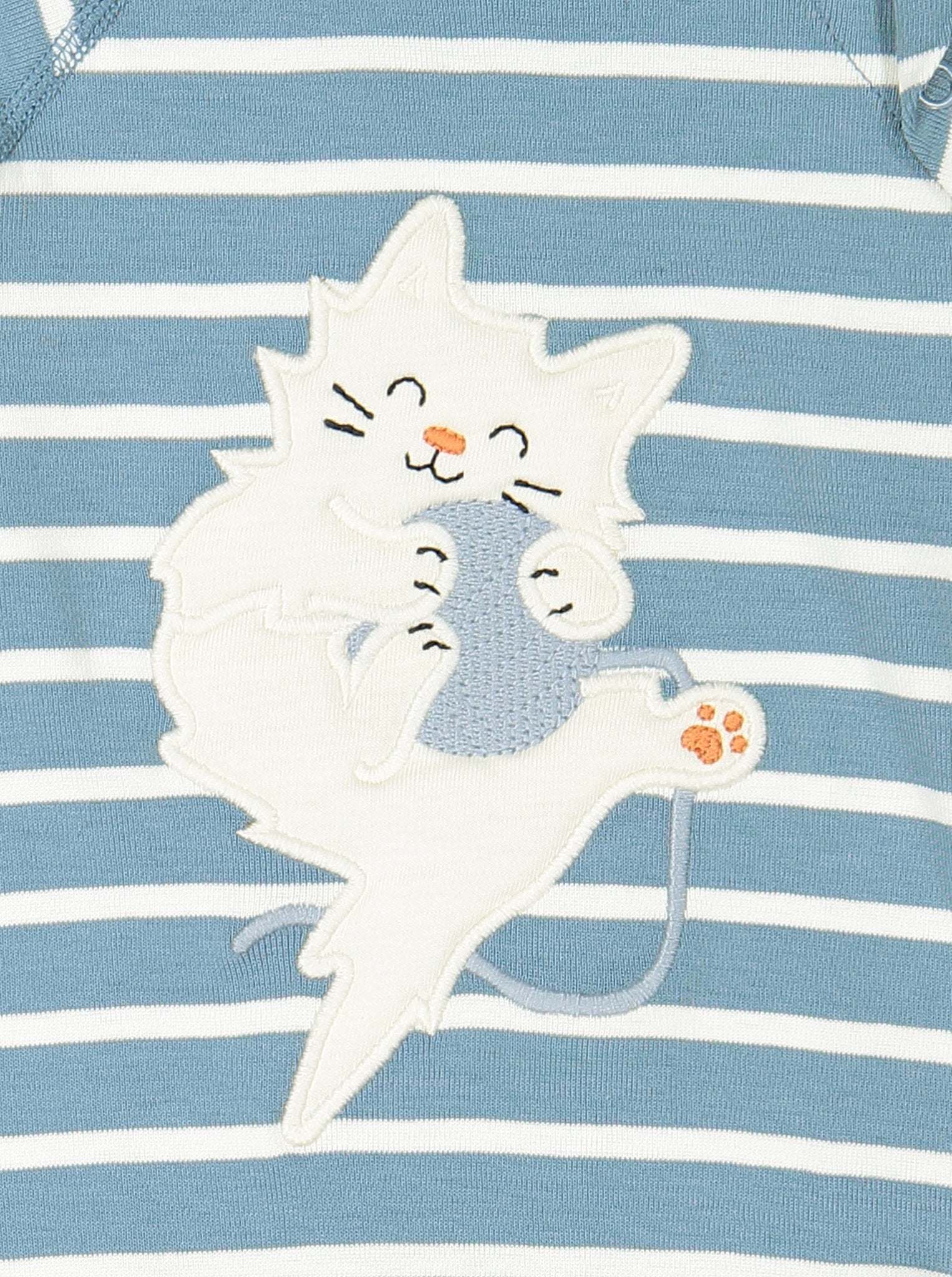 Close up of blue and white striped GOTS organic babygrow with adorable applique of kitten playing with a ball of wool