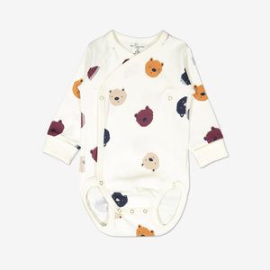 A white wraparound printed baby bear baby grow with cuffs, poppers, and flat soft seams. Made with organic cotton.