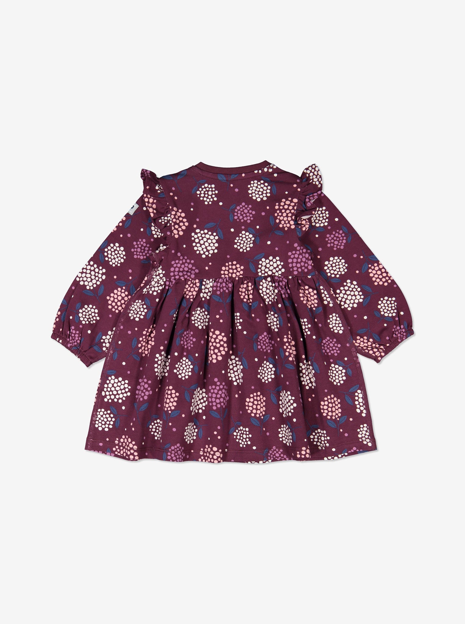 The back of a purple floral long sleeve baby dress, designed with shoulder ruffles. Made of organic cotton.