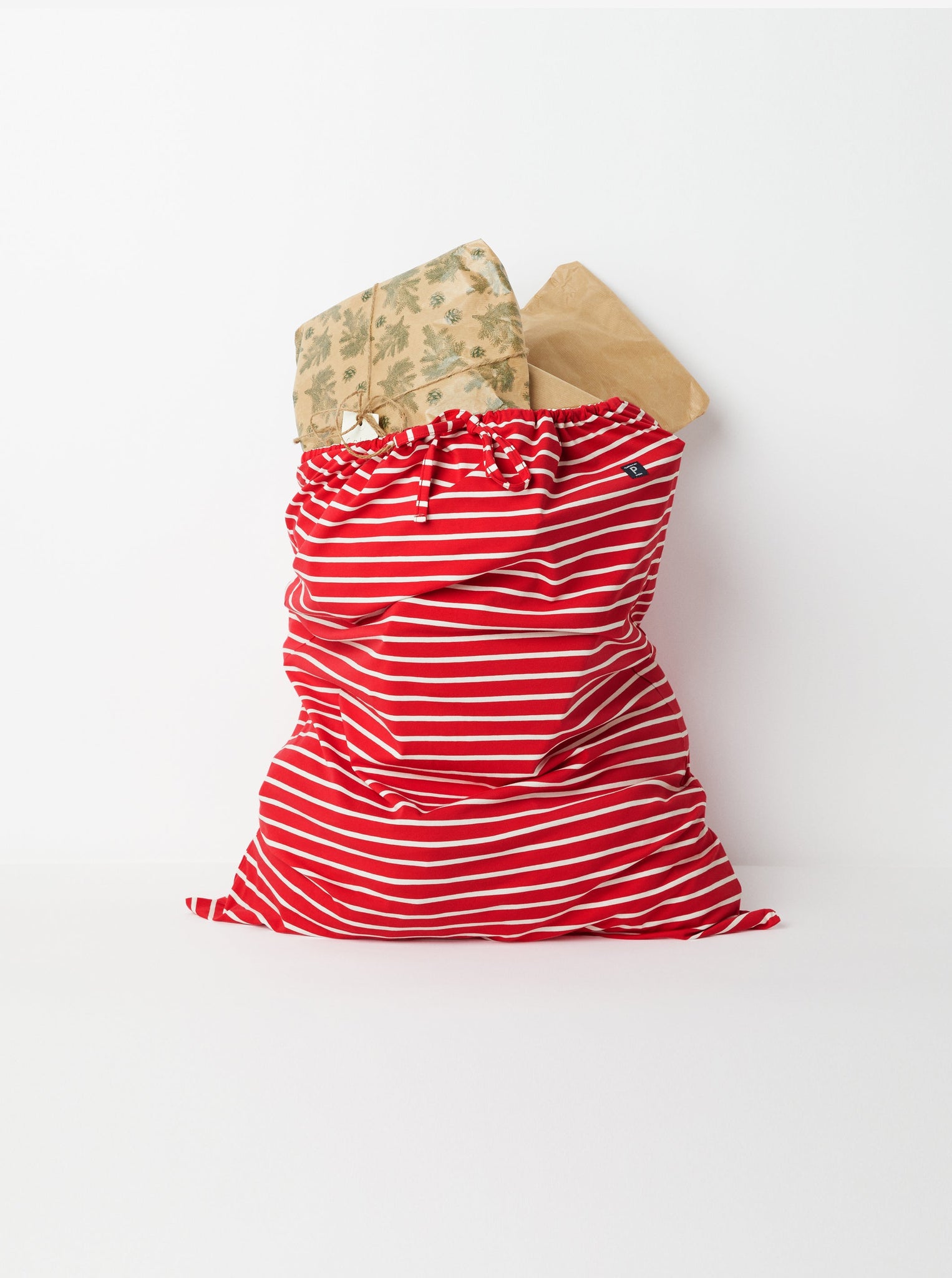 Red Christmas Present Sack from the Polarn O. Pyret kidswear collection. Made using ethically sourced materials