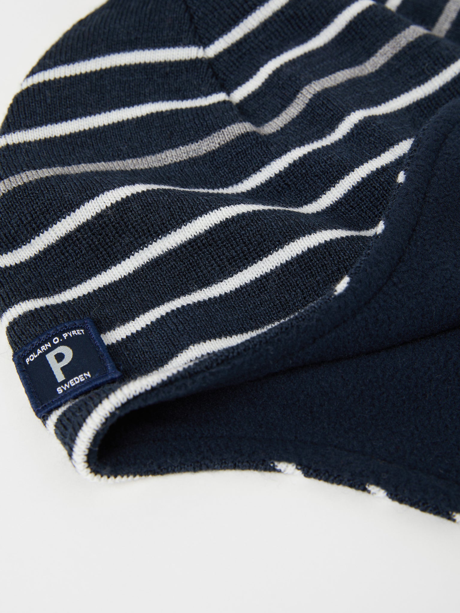 Merino Wool Navy Kids Bobble Hat from the Polarn O. Pyret outerwear collection. Ethically produced kids outerwear.