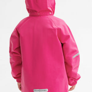 A kid wearing a pink, kids waterproof jacket, made of lightweight shell fabric, comes with reflectors and detachable hood.
