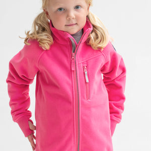 A young girl sporting a pink, kids waterproof fleece jacket made of breathable fabric, comes with cuff thumbholes.